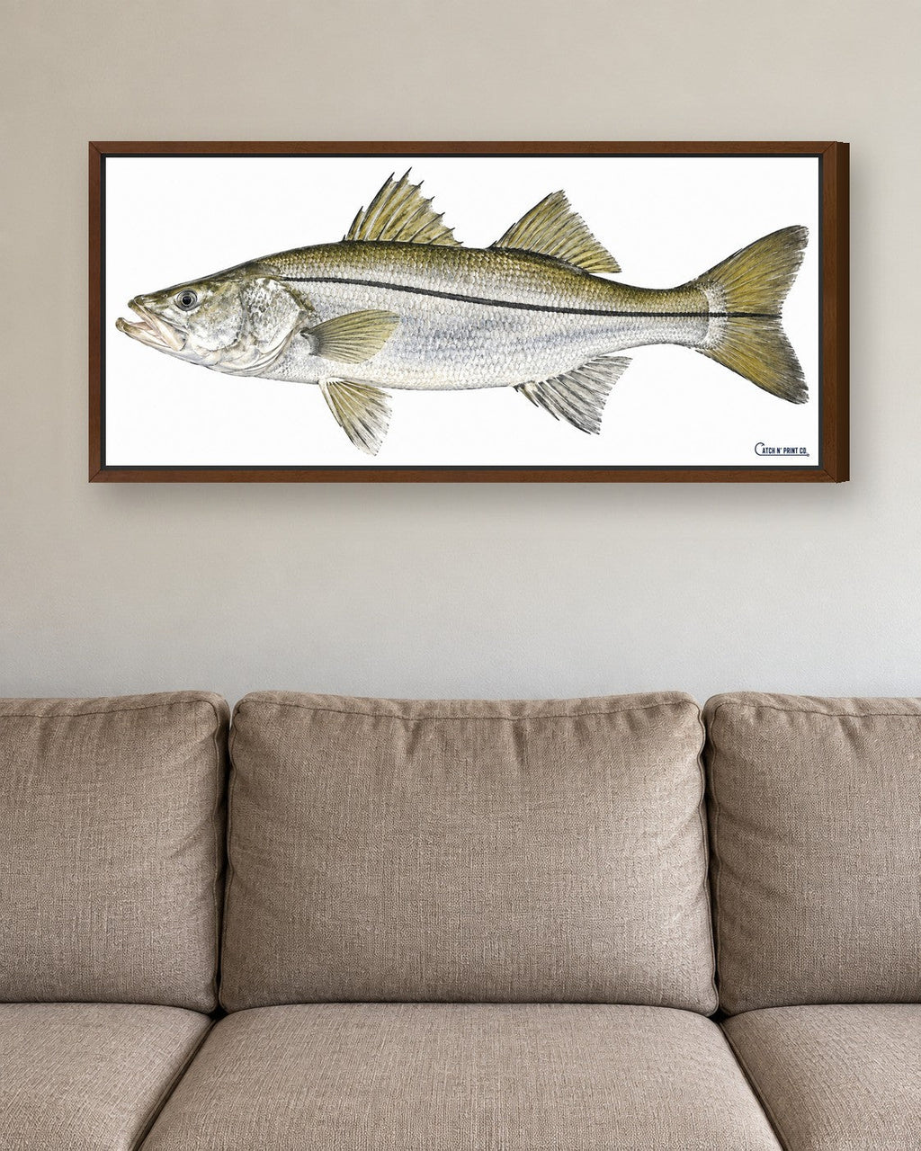 1.25in canvas in a Walnut floating frame, at true size above a sofa